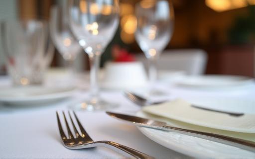 Elegant table setting with fine cutlery and glassware